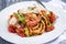 Italian linguine alla gamberetti with vegetable and parmesan on classic design plate