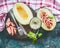 Italian lunch with ham and melon on rustic cutting board with glass of wine and cutlery on vintage background