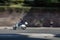 A italian man with helmet are driving a vespa/Scooter in the capital of Italy