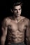 Italian man shirtless, abdominal gym. Black background