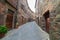 Italian medieval village details, historical stone alley, ancient marrow street, old city stone buildings architecture. Radicofani