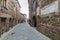 Italian medieval village details, historical stone alley, ancient marrow street, old city stone buildings architecture. Radicofani