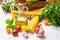 Italian and mediterranean cuisine ingredients, spaghetti, olive oil, garlic, tomatoes, artichokes, sweet pepper in basket on kitch