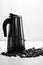 Italian moka coffee maker and coffee beans. Black and white