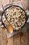 Italian Orzotto perlotto with porcini mushrooms and thyme closeup on a plate. Vertical top view