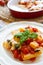 Italian Paccheri pasta with cherry tomato sauce, mozzarella cheese and fresh basil