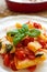 Italian Paccheri pasta with cherry tomato sauce, mozzarella cheese and fresh basil