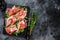 Italian parma prosciutto crudo dried ham on a marble board. Black background. Top view. Copy space