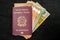 Italian Passport filled with Euro Banknotes on Dark Background. Travel ID and Cash Money. Travel Funds for Europe Vacation