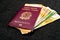 Italian Passport filled with Euro Banknotes on Dark Background. Travel ID and Cash Money. Travel Funds for Europe Vacation