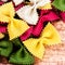 Italian Pasta as Textured Background close up. Raw Bow tie Colourful pasta macro. Italian Food.