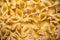 Italian pasta conchiglie cooked in a pan abstract backdrop. Traditional food