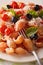 Italian pasta Conchiglie with tomatoes, olives and parmesan macr