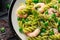 Italian pasta in a creamy pesto sauce with shrimp, prawns. closeup