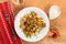 Italian pasta Farfalle with meat, olives, basil and mushrums. Rose wine glass and traditional wood dinner table. Top view.