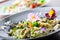 Italian pasta fettucine with chicken pieces and flowers decoration