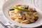 Italian pasta with roasted forest mushrooms and parmesan close-u