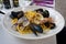 Italian pasta with seafood - mussels, vongole and shrimps. Closeup of seafood pasta served in Italian restaurant. Mediterranian