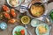 Italian pasta, snacks and salad on a light wooden table