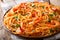 Italian pasta spaghetti with prawns, parmesan and herbs in tomato diavolo sauce close-up. horizontal