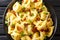 Italian pasta tortelloni with bacon, cheese and green onions close-up in a plate. horizontal top view