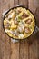 Italian pasta Tortiglioni with fried chicken in a cream cheese sauce closeup in a plate. Vertical top view