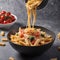 Italian pasta with vegetables, pouring tomato in bowl