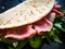 Italian piada wraps - piadina stuffed with fresh vegetable leaves and prosciutto ham on wooden table