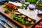 Italian piada wraps - piadina stuffed with fresh vegetables and roast chicken breast on wooden table