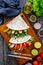 Italian piada wraps - piadina stuffed with fresh vegetables and roast chicken breast on wooden table, top view