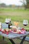 Italian picnic with red wine, parmesan, ham and olives. Lunch in the open air. Traditional snacks. Copy space