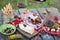 Italian picnic with red wine, parmesan, ham and olives. Lunch in the open air. Traditional snacks. A man pours a glass of wine.