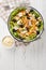 Italian Piedmontese salad with chicken, mushrooms, carrots, celery, olives, cheese and lettuce close-up in a bowl. Vertical top