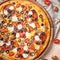 Italian pizza. Close-up. View from above. Bright, colorful tones, pastel background. Beautiful slices of tomatoes, olives,