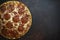 Italian pizza pepperoni on dark stone background