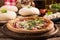 Italian Pizza with rocket salad on wooden table