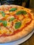 Italian pizzeria, pizza with mozzarella, pizza margherita, classic Italian restaurant, basil on pizza