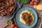 Italian pork ragout with creamy polenta and green beans on wooden table