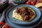 Italian pork ragout with creamy polenta on a plate