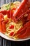 Italian recipe of spaghetti with boiled lobster, tomatoes, lemon