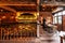 Italian Restaurant decorated with brick in warm light that created cozy atmosphere with waiter on the right table.