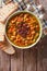 Italian ribollita soup close up in a bowl. vertical top view