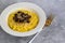 Italian risotto with champignons and parmesan on a gray background. Rice is seasoned with turmeric and herbs.