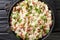 Italian risotto Risi e Bisi made from rice with peas and ham close-up in a plate. horizontal top view