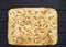 Italian rustic bread - classic focaccia with rosemary and olive oil on a black wooden background - top view and copy space