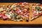 Italian rustic pizza, three pieces on a wooden tray, dark wooden table