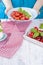 Italian salad with caprese. Salad of fresh vegetables and cheese. Ceramic tableware. Free space for text. Towel in a red cage.