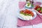 Italian salad with caprese. Salad of fresh vegetables and cheese. Ceramic tableware. Free space for text. Towel in a red cage