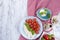 Italian salad with caprese. Salad of fresh vegetables and cheese. Ceramic tableware. Free space for text. Towel in a red cage