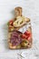 Italian sausage, bread ciabatta, olives and cherry tomatoes in olive Board